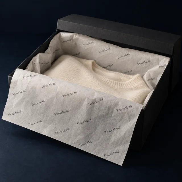 Custom printed tissue paper lining a branded gift box