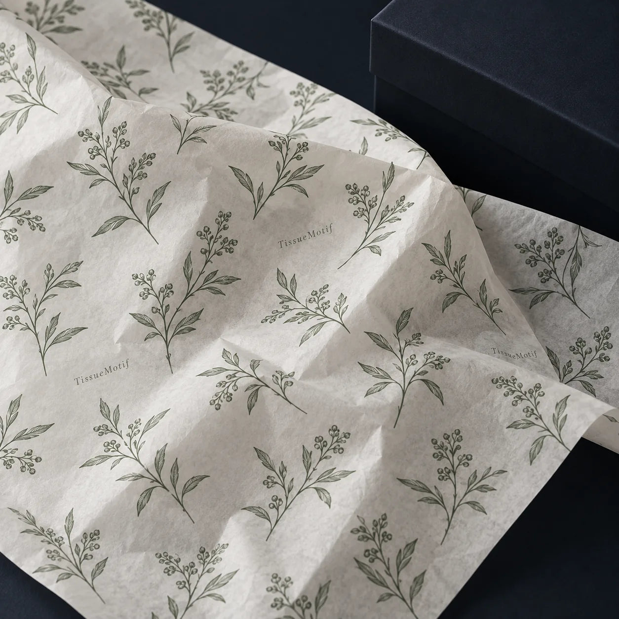 Fine botanical line artwork printed in one green ink across natural white tissue