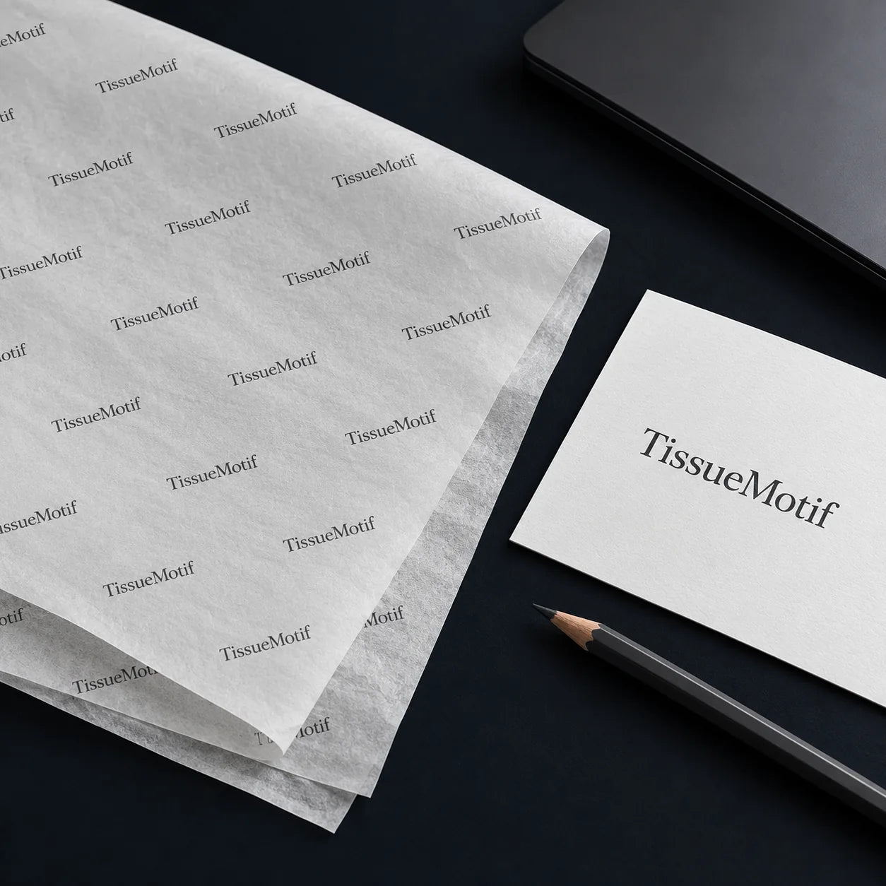 A single-color tissue print beside its wordmark proof card and a graphite pencil